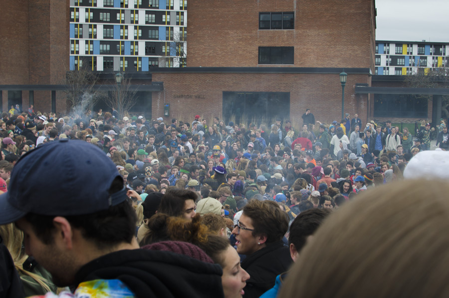 OLIVER POMAZI | The Vermont Cynic
UVM students gather on the Redstone Green April 20 to participate in 4/20 activities as UVM Police look on.