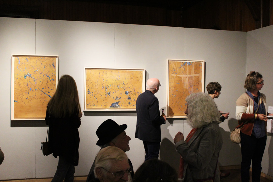 Vermont community members admire the art at the fifth annual “Of Land and Local” art show Oct. 6 at Shelburne Farms. This year’s exhibits focus on watersheds and their impact on the environment.