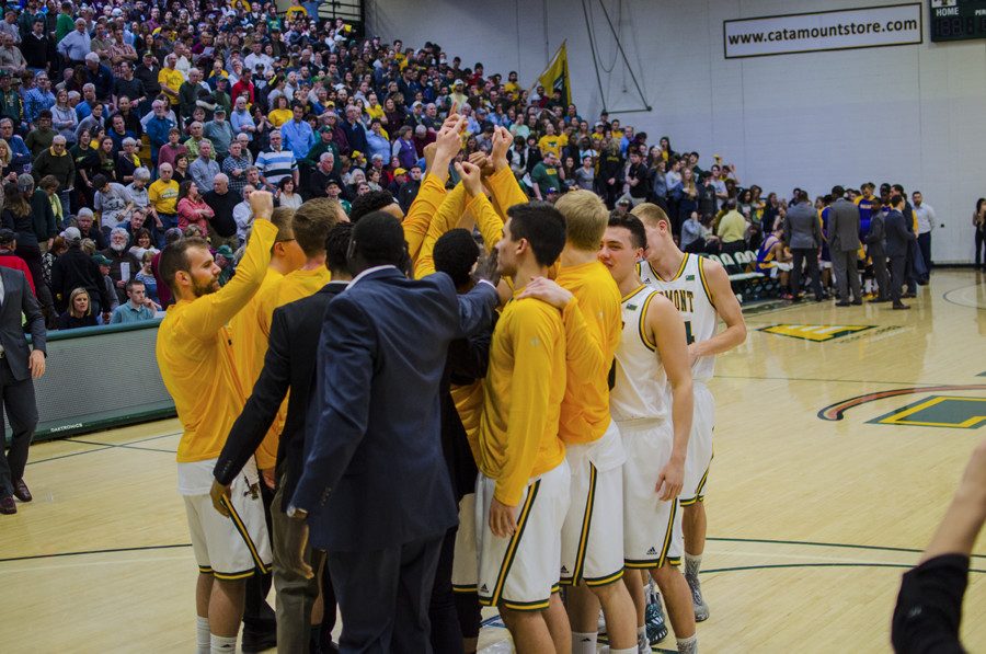 The mens basketball team huddles together before a game in February 2017. 