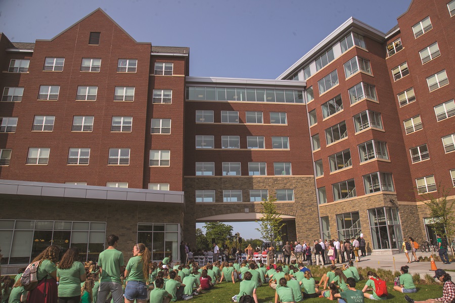 Wellness Environment students sit outside the Central Campus Residence Hall Sept. 15 for the ribbon-cutting ceremony celebrating the new dorm.