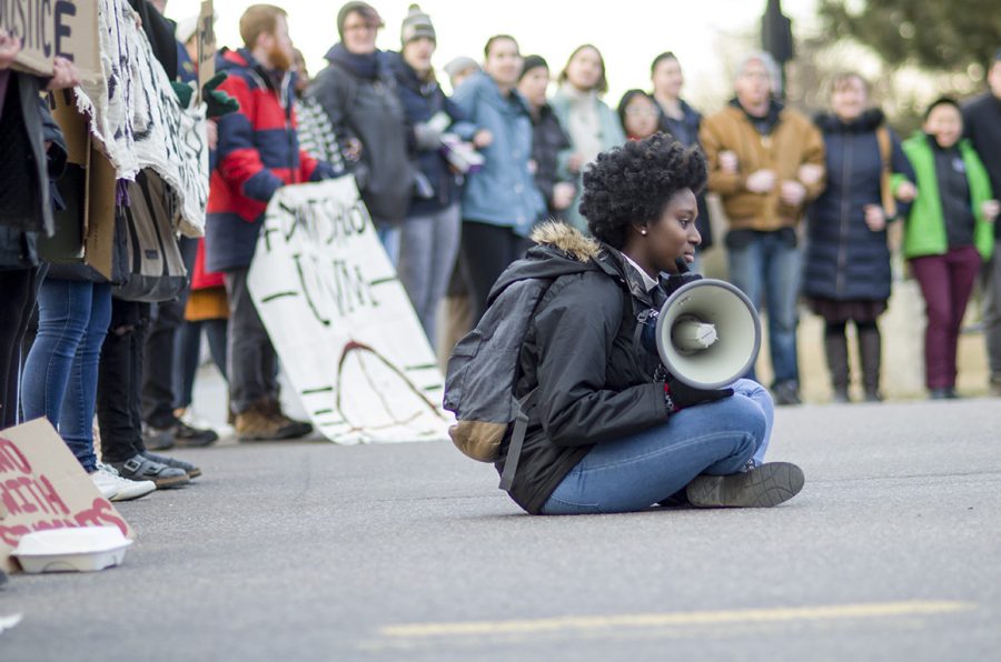 NoNames for Justice form form a line blocking Main Street Feb. 22. They chant “Students of color deserve respect; we’re sick of the school’s neglect.”