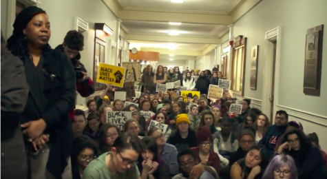 Students outside Tom Sullivan’s office call him to come outside
