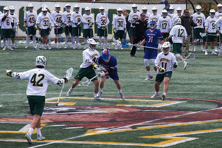 Sophomore Ben French and freshman Liam Limoges double-team an opposing player in the UVM Lacrosse 14-7 win against UMass Lowell. French and Limoges scored scored 4 and 5 goals each respectively.