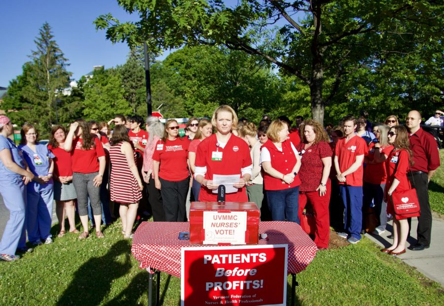 Representatives from the nurses union stand behind lead negotiator, Julie MacMillan as she announces a vote in favor of striking.