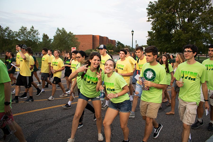 Students process from Patrick Gym down Main Street to the Twilight Induction on the Waterman Green.