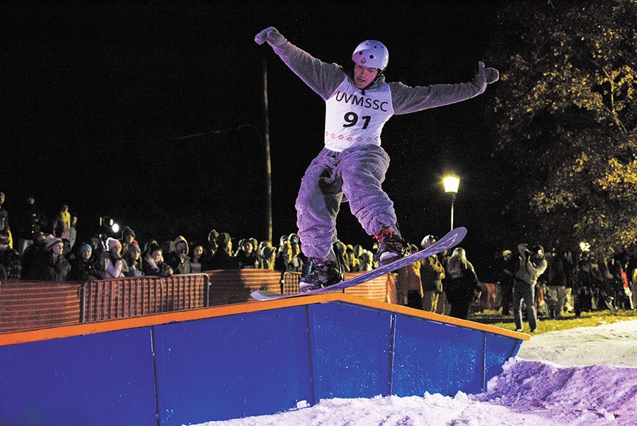 Senior Diego Travino grinds a rail in an all gray onesie at the Dawn of the Shred X: the Human SENDipiede rail jam, hosted by the UVM Ski and Snowboard Club Oct. 25.