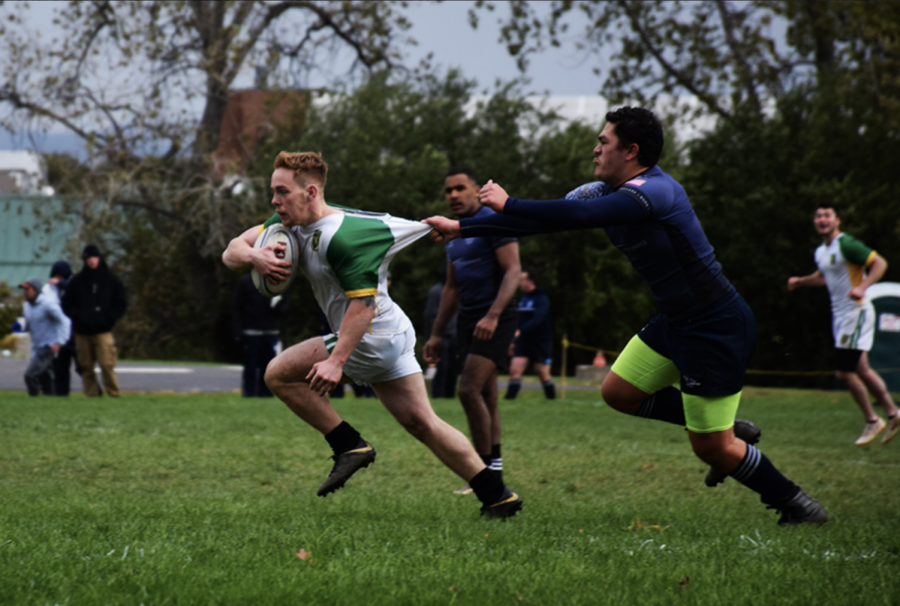 Blindside flanker Pat Rainford pulls away from the grip of a Quinnipiac Men’s Rugby Team player Oct 21. The team defeated Quinnipiac with a final score of 68-15.