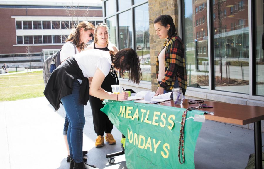 Sophomore Margaret Thomson tables outside of Central Campus Dining Hall for Meatless Mondays April 25, 2017. Green Mountain Veggies is starting Meatless Mondays at UVM dining halls on a small scale Nov. 12 and 26 as well as Dec. 3 and 10.