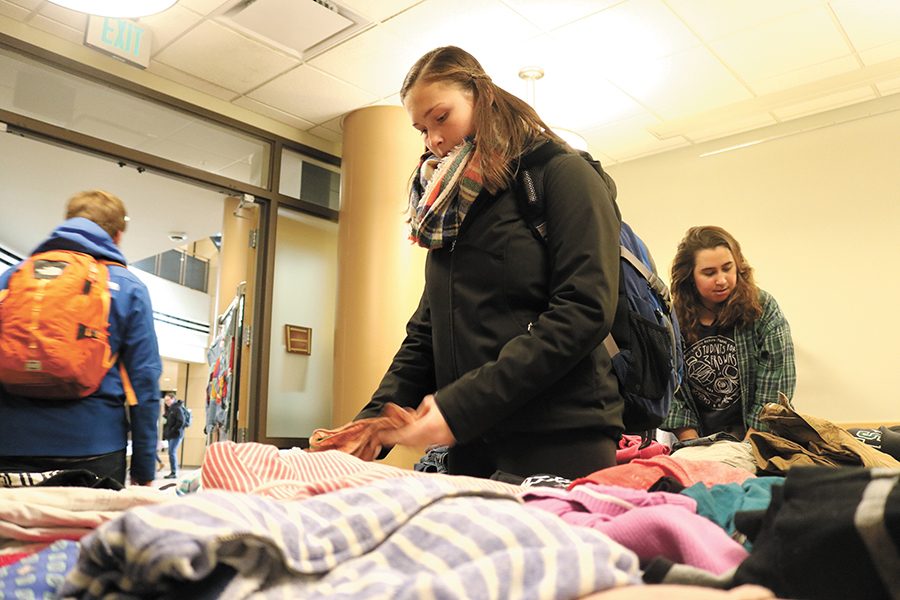 Sophomore Emilie Begin looks through shirts at the Vermont Student Environmental Programs thrift shop initiative called Cats Closet, located in the Rosa Parks Room in the Davis Center.