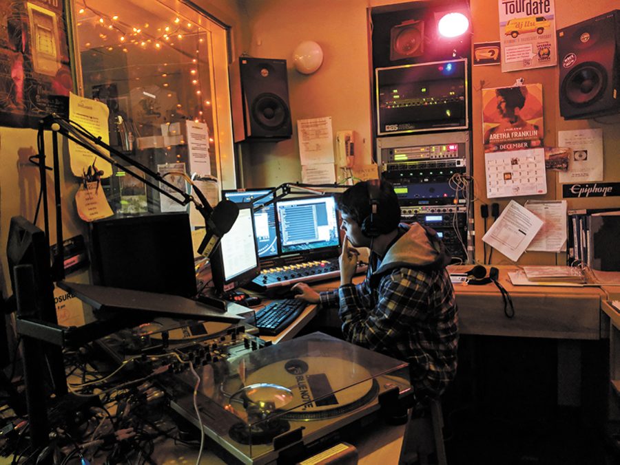 First year Charles Guglielmo hosts his radio show in the WRUV radio station Dec 2. WRUV FM Burlington provides students with an eclectic mix of genres of music while also providing students with technical training and opportunities to broadcast.