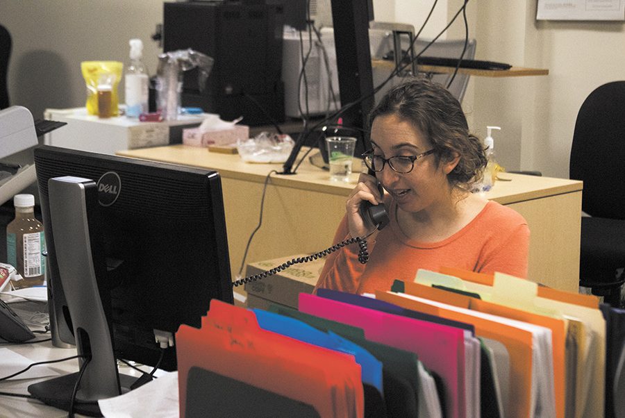 A worker at the Vermont Consumer Assistance Program takes a call Jan. 18. Students can work for CAP by mediating disputes between businesses and consumers, spreading information about scams in the Vermont area, for class credit.