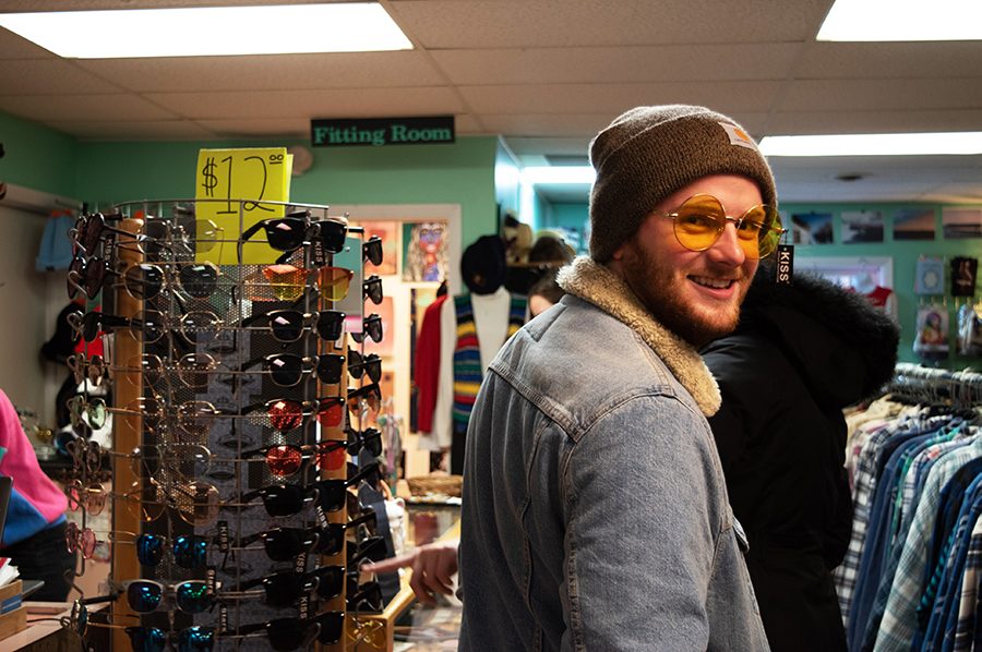 Sophomore Jonathan Barte tries on a pair of $12 sunglasses at Downtown Threads, located in the heart of Church Street. Downtown Threads is unique in that you have the option to fill a bag with clothes from a trunk for $5.
