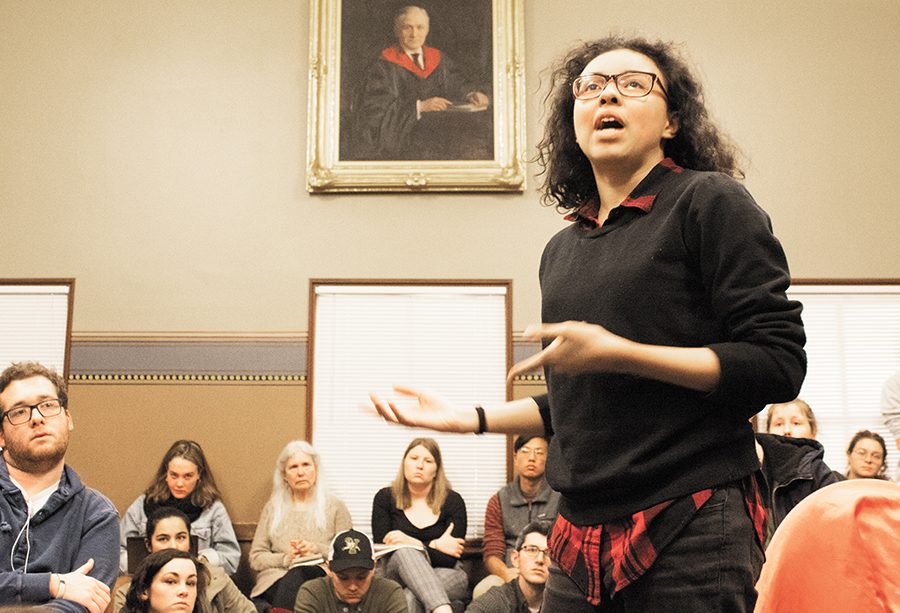 A portrait of UVM graduate John Dewey, a philosopher and proponent of an education as a means of social reform, overlooks the John Dewey Lounge as sophomore Charlotte Looby delivers an impassioned speech Feb. 5 at a United Academics meeting. 
