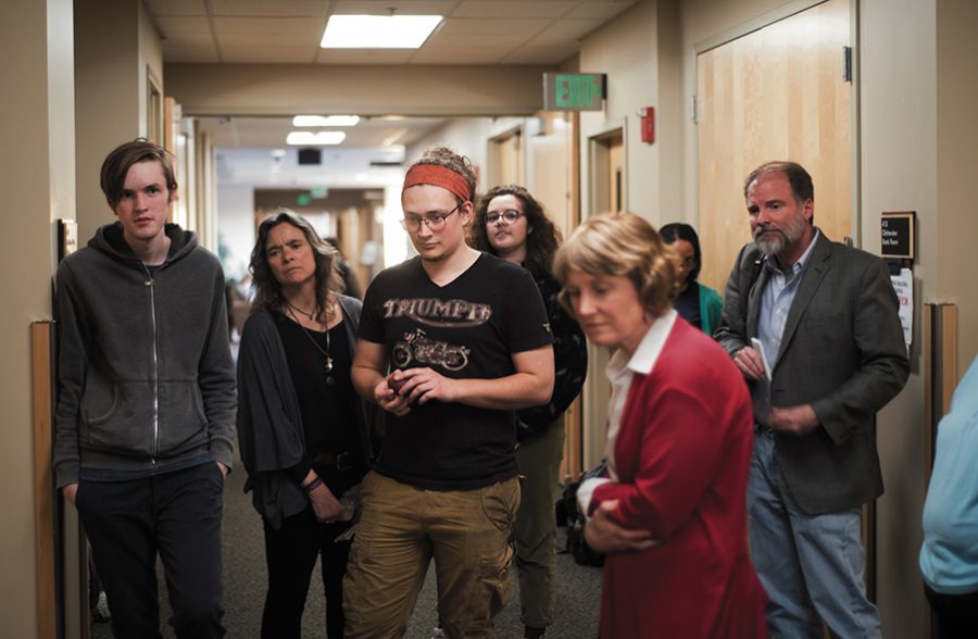 Protesters, including junior Alexander Smith and English professor Nancy Welch, listen to senior Scarlett Moore recount the events of the trial April 4. Im here because, number one, I think this is a really egregious attack on the free speech of queer students and students of color, Moore said. 