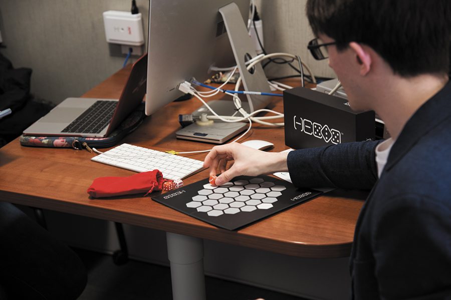 Sophomore Brandon Levesque demonstrates how to play Hexix, a new board game he and his team created. The Hexix team traveled to Boston March 28 for PAX East, a gaming convention where a variety of developers showcase their games.