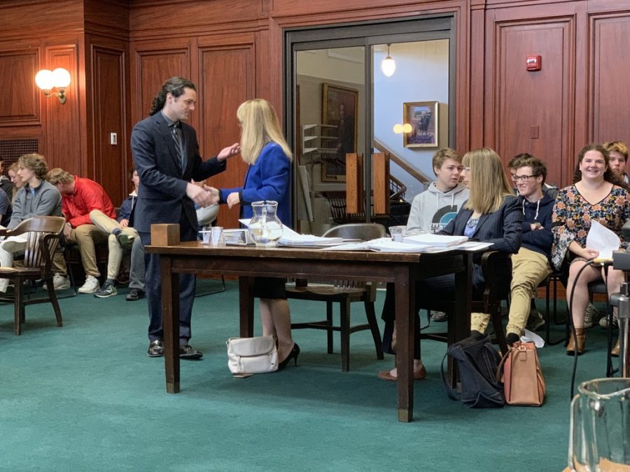 Jacob Oblak (left) shakes hands with UVMs General Counsel Sharon Reich Paulson (right) just before their case is heard in front of the Vermont Supreme Court. 