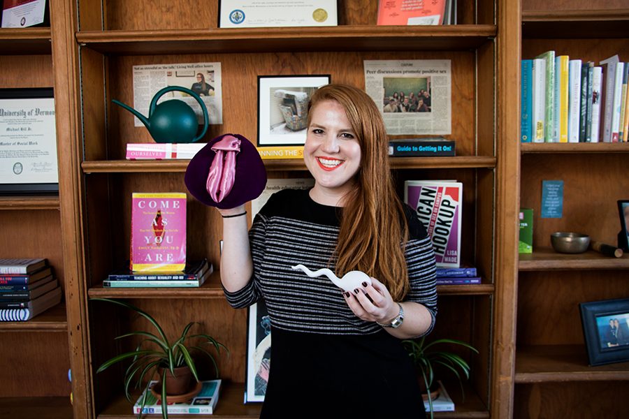 Sex education expert Jenna Emerson poses in her office in Living Well with models of vaginas and sperm, Aug. 28. One reason Emerson’s office hours are popular is her work in comedy. Her live comedy show “Sex with Jenna” links her two professions.