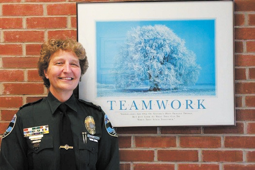 UVM Police Services Chief Lianne Tuomey stands in front of a framed picture that says ‘teamwork.’ Tuomey went on a leave of absence beginning July 11 and remains on an indefinite paid leave, according to UVM Spokesman Enrique Corredera.
