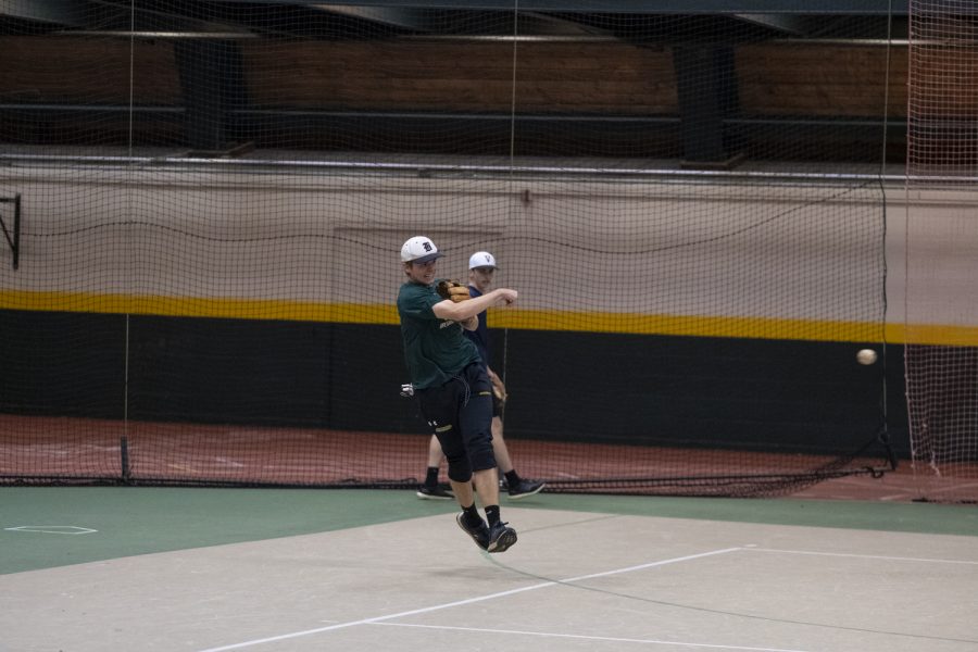Junior Pat Brennan throws a baseball in midair during a club baseball practice, Oct. 17. Brennan is one of the 18 members of the team, according to UVM Clubs.
