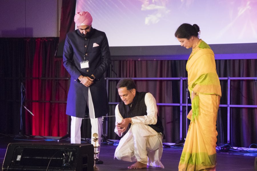 Suresh Garimella (Kneeling) and his wife Lakshmi light the ceremonial lamp that signifies the start of Diwali, Oct. 27. This year’s celebration falls on the exact day of Diwali.