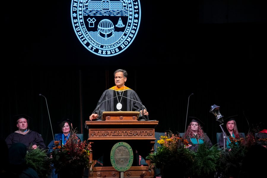 President Suresh Garimella speaks at convocation, Aug. 25. The University seal hangs on the podium and is projected on the curtain behind him.