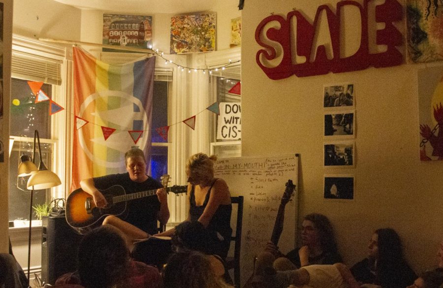 Senior Clay Maroney (Left) and junior Courtney Smith (Right) perform at Slade Cooperative’s “Coffee Haus,” Oct. 10. Slade, an off-campus housing option for students, was founded as a way for student activists to form a community based in sustainability.