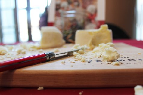 Cheese and a knife rest on a cutting board during the UVM Cheese and Dairy fest, Feb. 19. The event was held in the Davis Center and sponsored by UVM Dining.