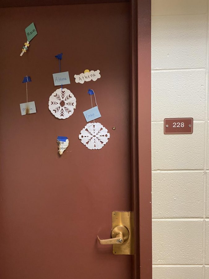 Paper decorations and a notice of room inspections show the lingering marks of fire. Five first-years were charged with arson after setting paper decorations on several doors on fire, according to UVM Police Services. 