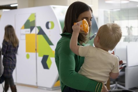 Mamava employee Erica Hutchins holds her 1-year-old son at the lactation station reveal, Feb. 4. Mamava is a women-owned company with all products made within the U.S.