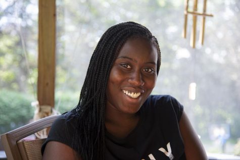 Noel Ruby-Williams sits on a porch in the home of the children she nannies for in Montpelier, Vermont.