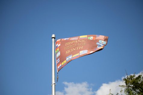 A Hispanic Heritage month flag blows in the wind on a flagpole in front of the Davis center, Sept. 18.