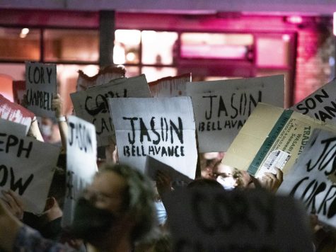Protesters march down Church Street Sept. 4 holding signs with the names of three police officers involved in use of force incidents.