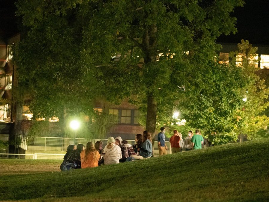 A group of students sit together on the Redstone Green, Sept. 11. Students had gathered in large groups several days before over Labor Day weekend, drawing UVM Police to the scene.