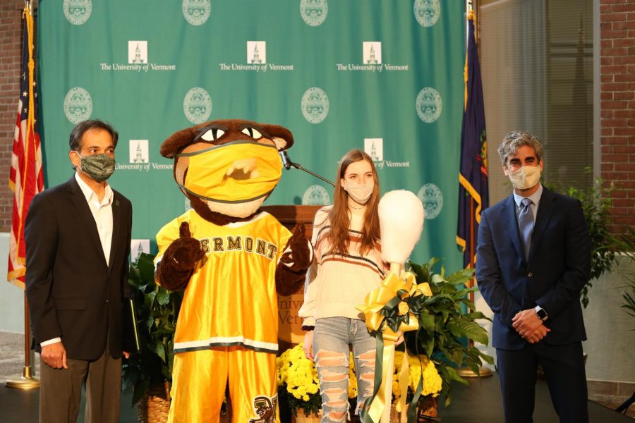 UVM President Suresh Garimella, Rally Cat, first-year Emily Scarborough and Burlington Mayor Miro Weinberger pose for a photo in the David Center Atrium to celebrate UVMs 100,000th COVID-19 test Oct. 27.