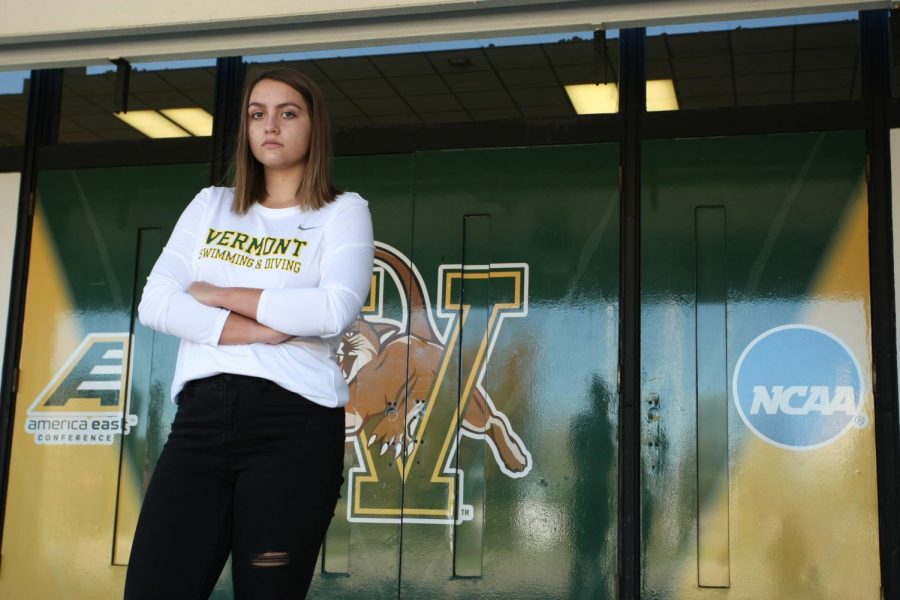 Junior Kendall Ware stands in her Vermont Swimming and Diving shirt in front of the Patrick Gym, Oct. 9. Ware will be graduating this year to enter a Speech Pathology grad program at UVM.