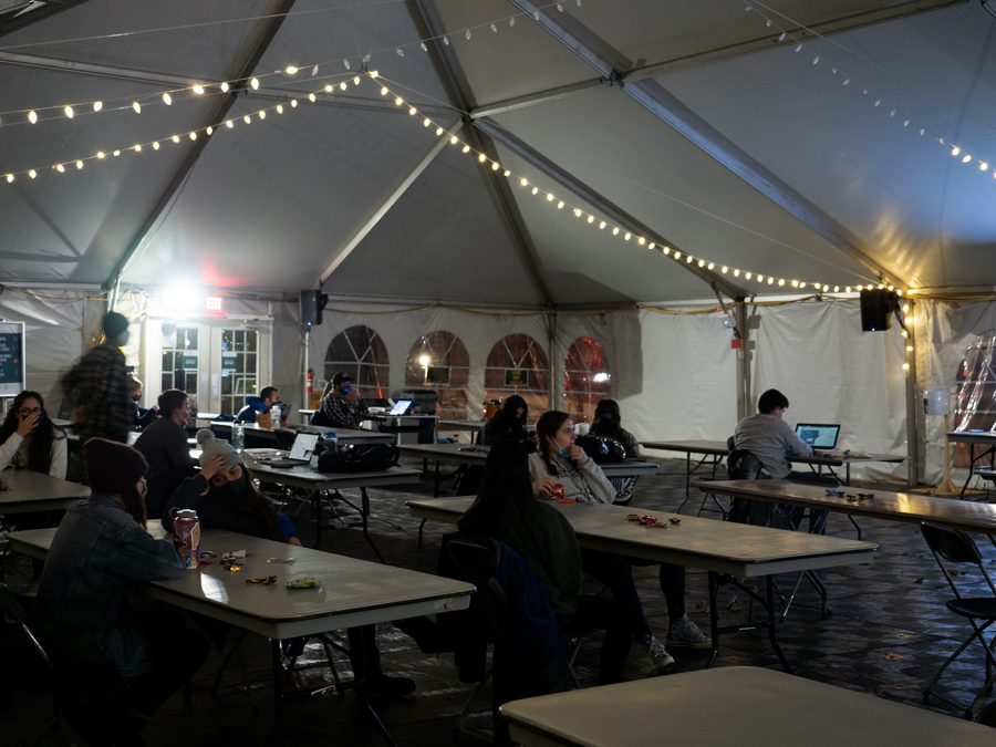 Nervous students watch election night news coverage in a tent of the Davis Center green Nov. 3. “Ive been stressed all day, all week. Really, the last few months,” first-year Chloe Bouska said. “Theres been a lot of anticipation leading up to it but now that its here its, well, its crunch time.”