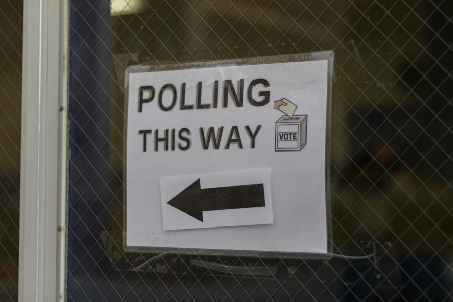 Signs indicate where the entrance to the polling place is to potential voters Nov. 3. 