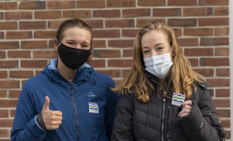 Junior Olivia Gaissert (left) and Sophomore Waseya Lawton (right) stand outside the Mater Christi School Nov. 3. Both students decided to drop off their mail-in ballots in person instead of mailing them in.