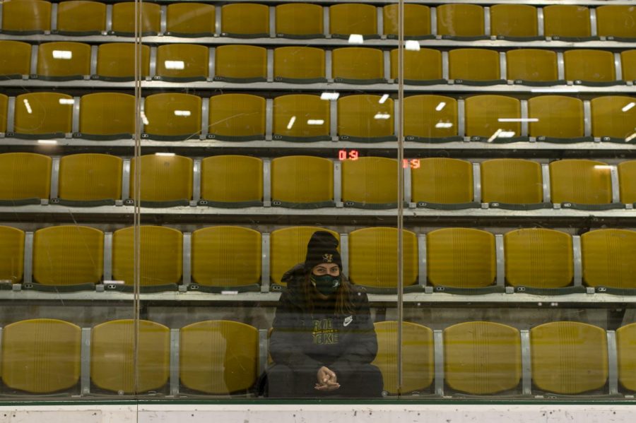 Sophomore Cam Morrissey sits in the empty bleachers of the Gutterson Fieldhouse Dec. 6. Morrissey trains with her team five days a week during the winter.