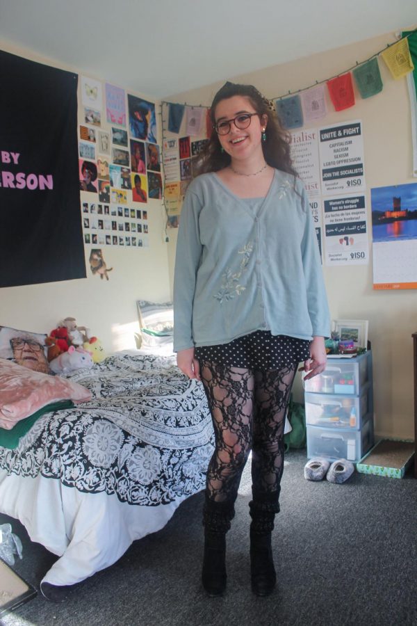 Shea stands in the center of her bedroom showing off her outfit consisting of tights from her halloween costume, a skirt from H&M, a sweater from Goodwill and legwarmers Jan. 30.