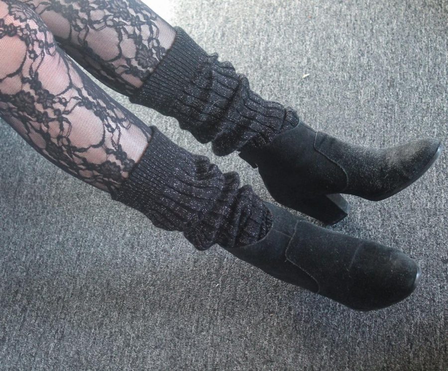  Shea sits on the edge of her bed showing off the leg warmers she layered over her tights Jan. 30. Shea bought these tights for her Halloween costume when she dressed up as Patricia from House of Anubis.