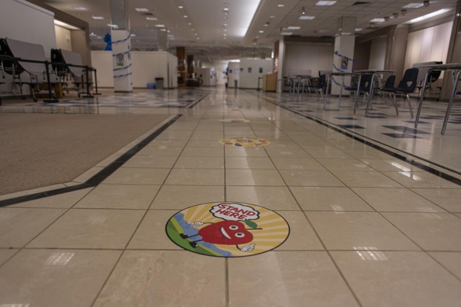 Floor decals show demonstrate social distancing in the hallway near the study hall area March 16.