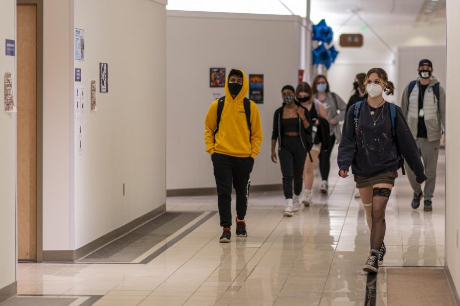 Students walk in the hallway together socially distanced and with masks on March 16.
