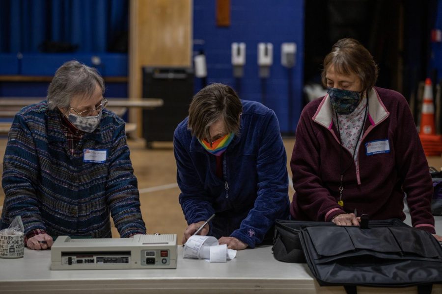 Three Ward 1 election inspectors review the ballot receipt before sealing it inside the tabulation bag March 2.