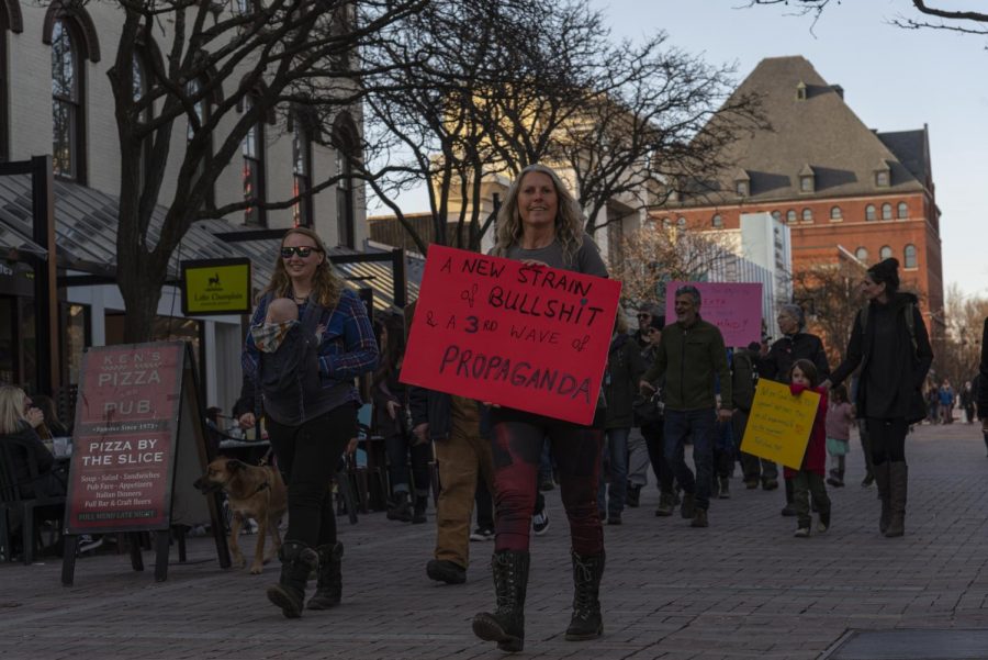  A woman leads the group of anti-mask protestors down Church street March 20.
