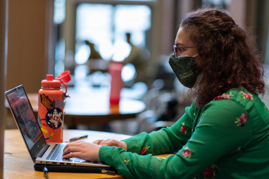 Sophomore Althea Deschenes sits in the Davis Center doing homework while wearing double masks Feb. 19.