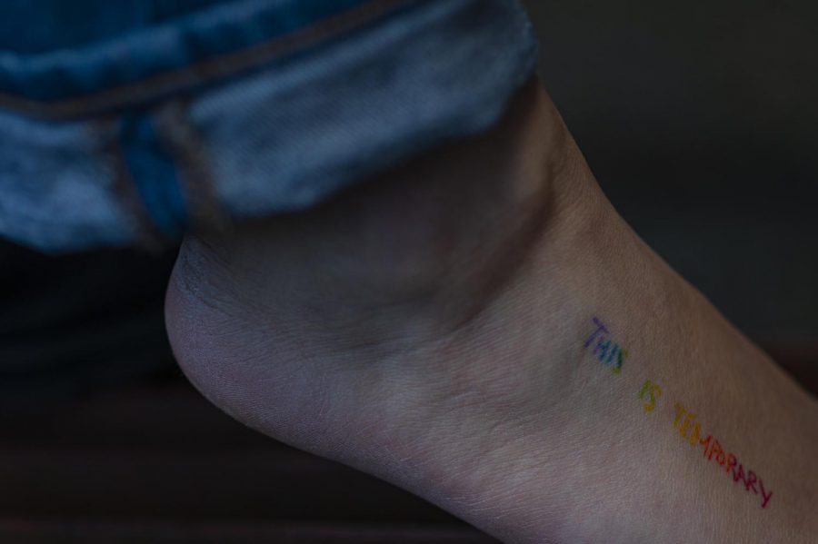 Hennessey removed her sock to show her rainbow “this is temporary tattoo March 16. This tattoo is her own handwriting. All of her tattoos are her original designs and sketches.