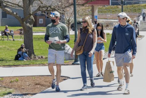 The family of a prospective student walks through Andrew Harris Commons without observing proper masking protocols April 10.