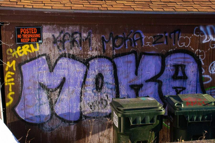 Graffiti tags are painted on the side of a shed with a ‘No Trespassing’ sign April 8.