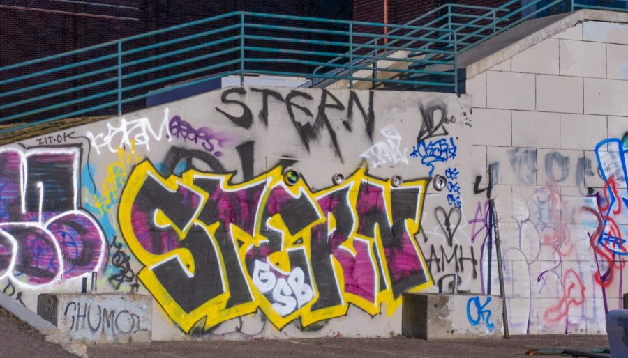 A collection of graffiti tags are found on the side of a staircase in downtown Burlington April 8.